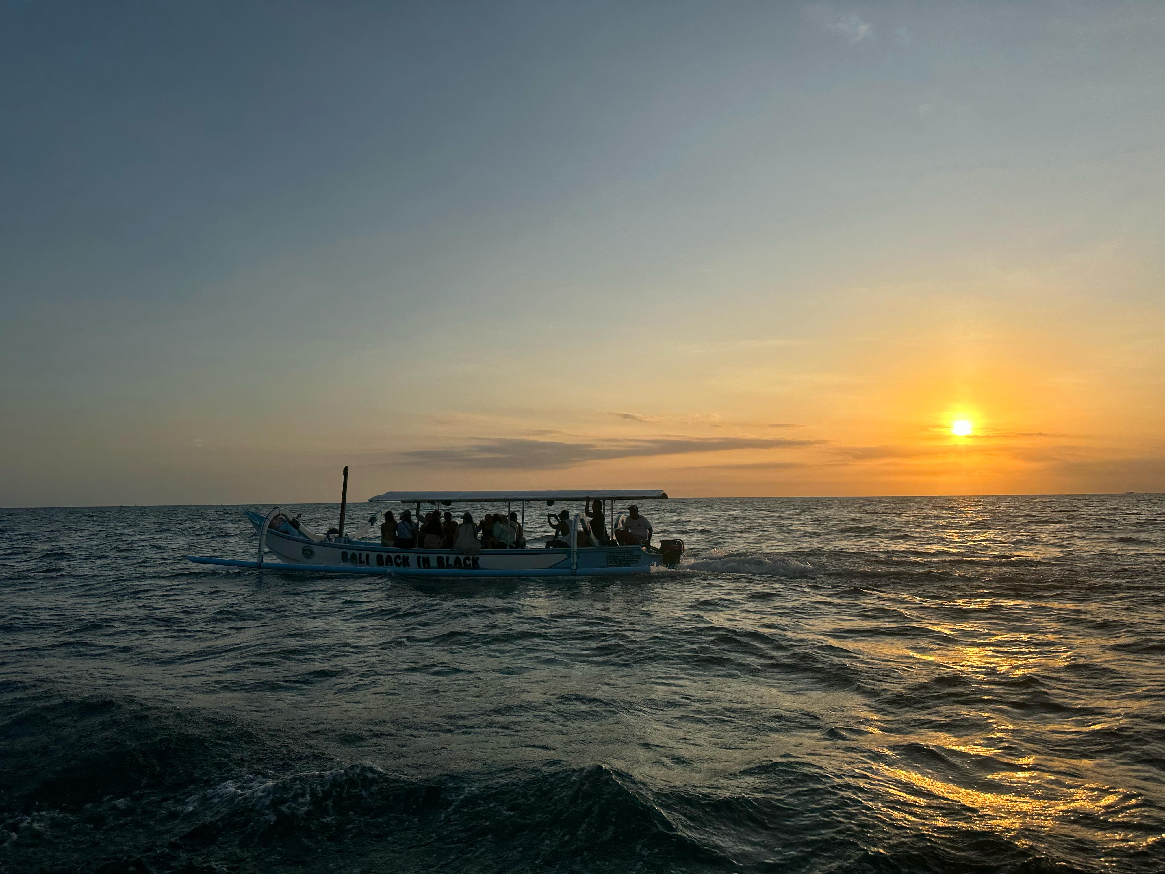 Bali Back In Black boat cruising at sunset on the Indian Ocean